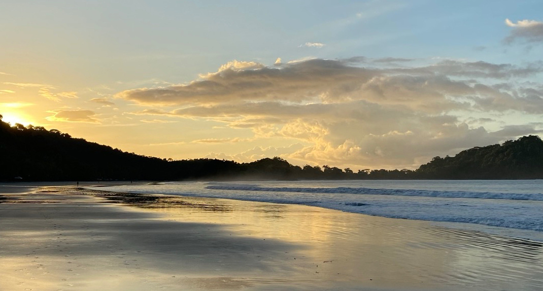 Sunset over a quiet beach at low tide