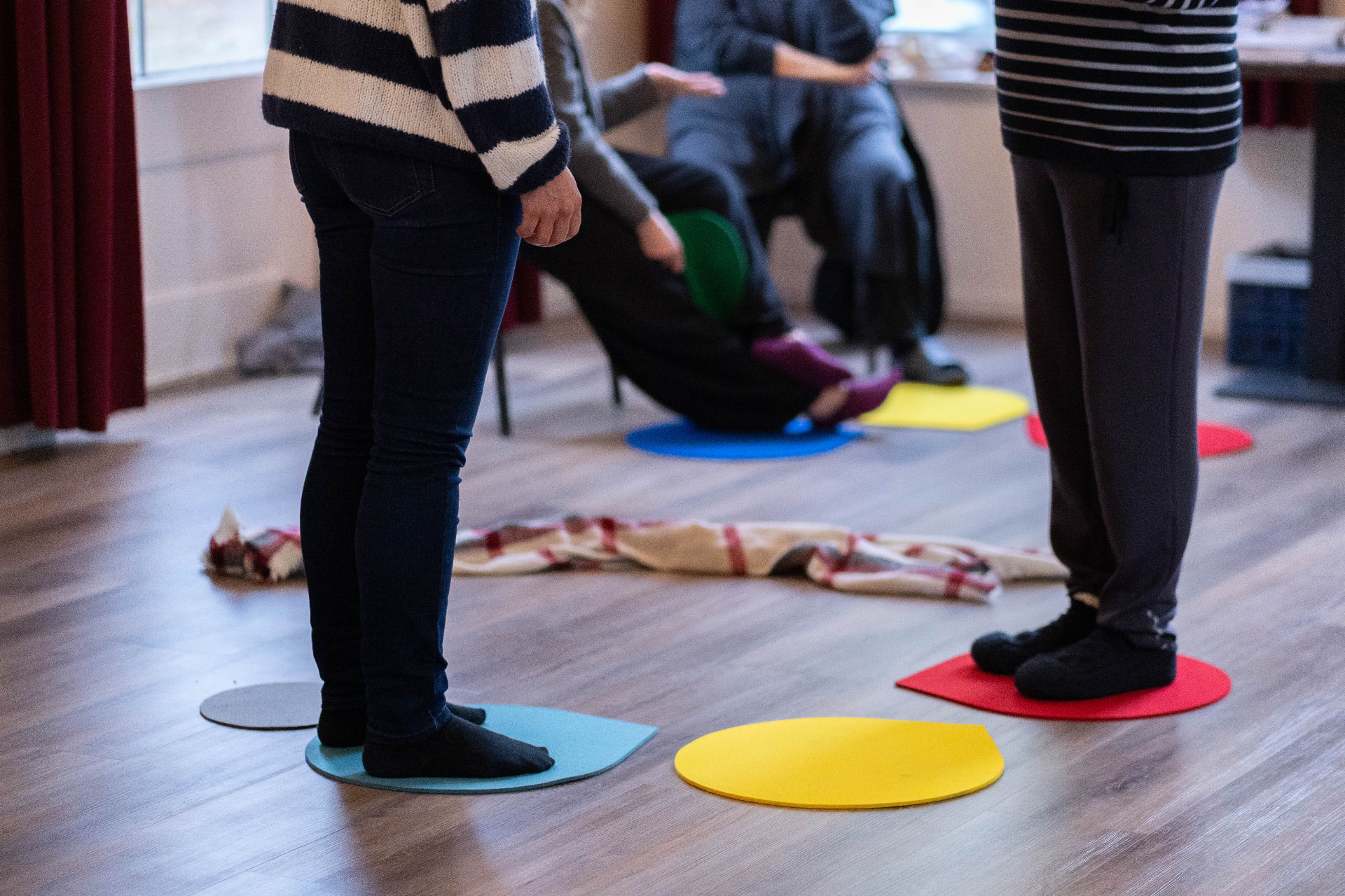 Participants working with coloured floor markers during a Business Constellations training