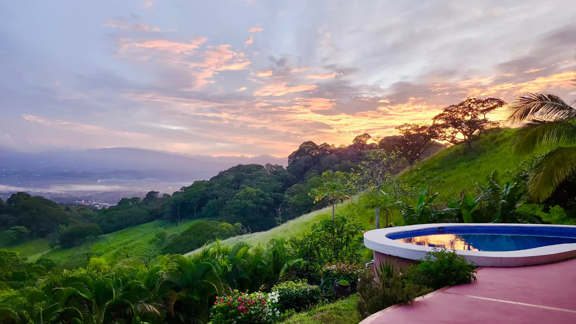 Sunset over the hills and pool at the Atenas property